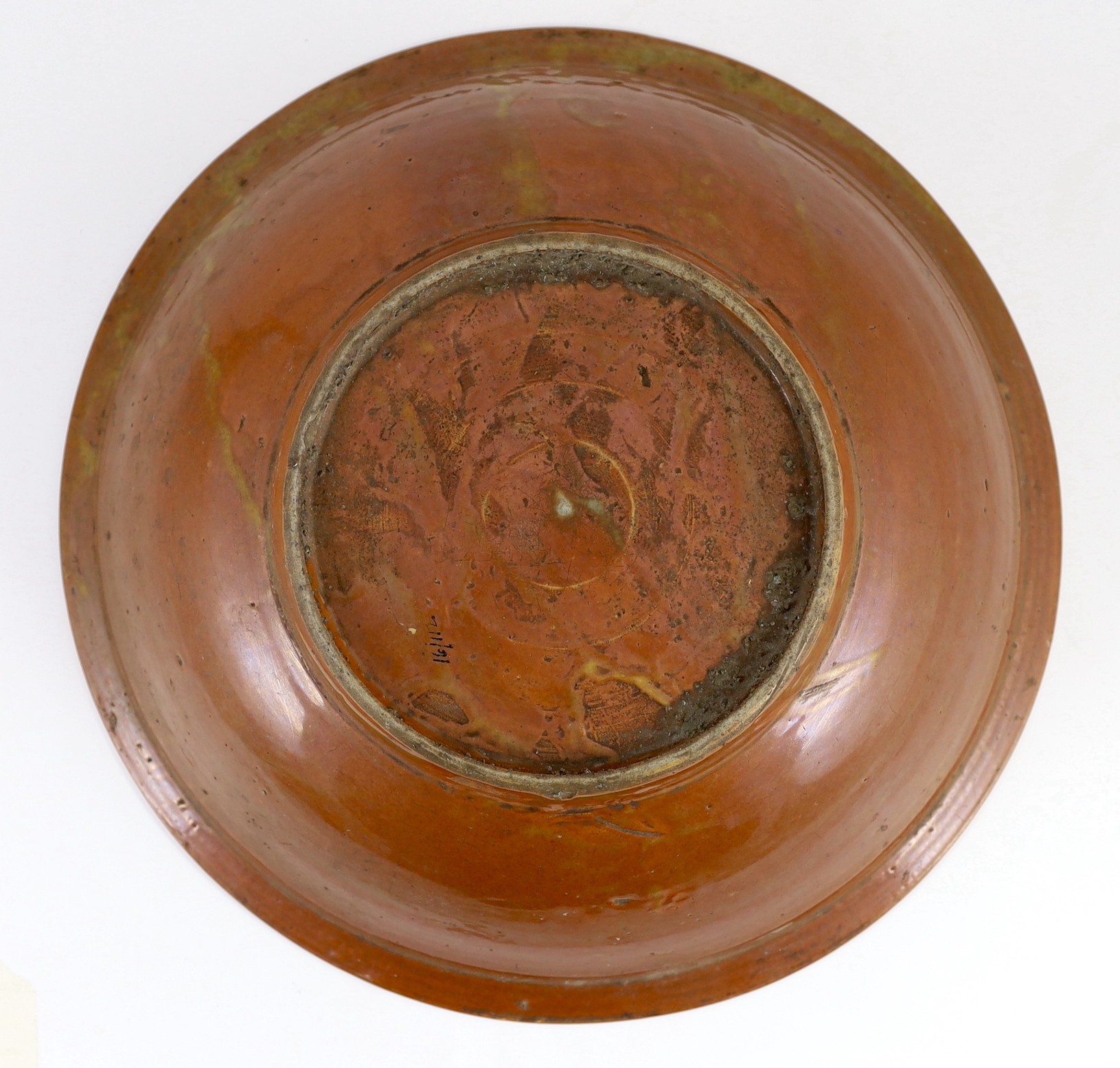 A Chinese Swatow slip-decorated brown ground dish, Zhangzhou kilns, early 17th century, 37cm diameter